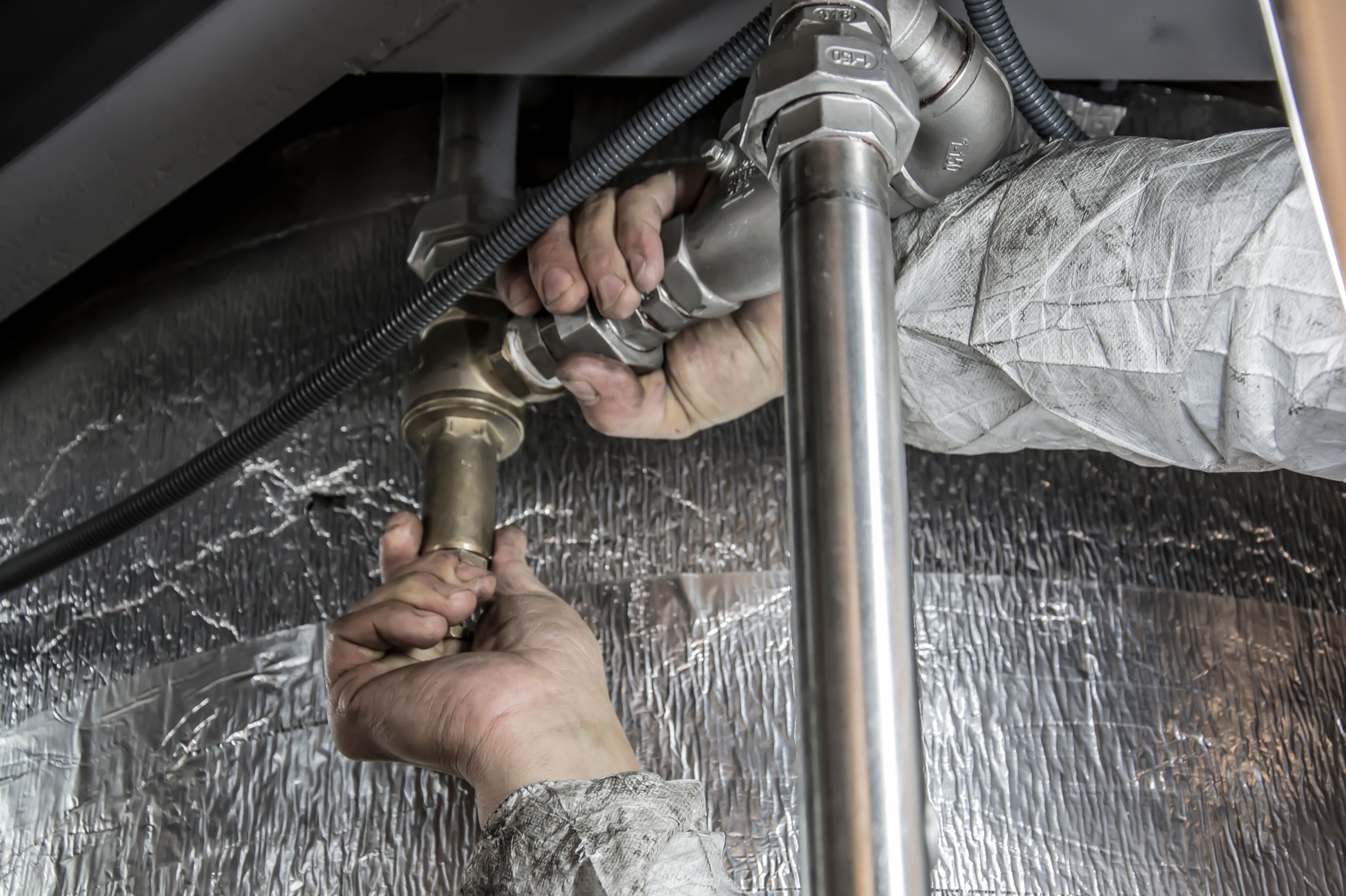 A plumbing repair being completed in a Northern Virginia home